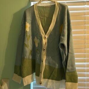 Women’s sweater button down. Has a sunflower print on the front and back. New
